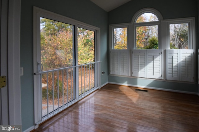 unfurnished sunroom with vaulted ceiling