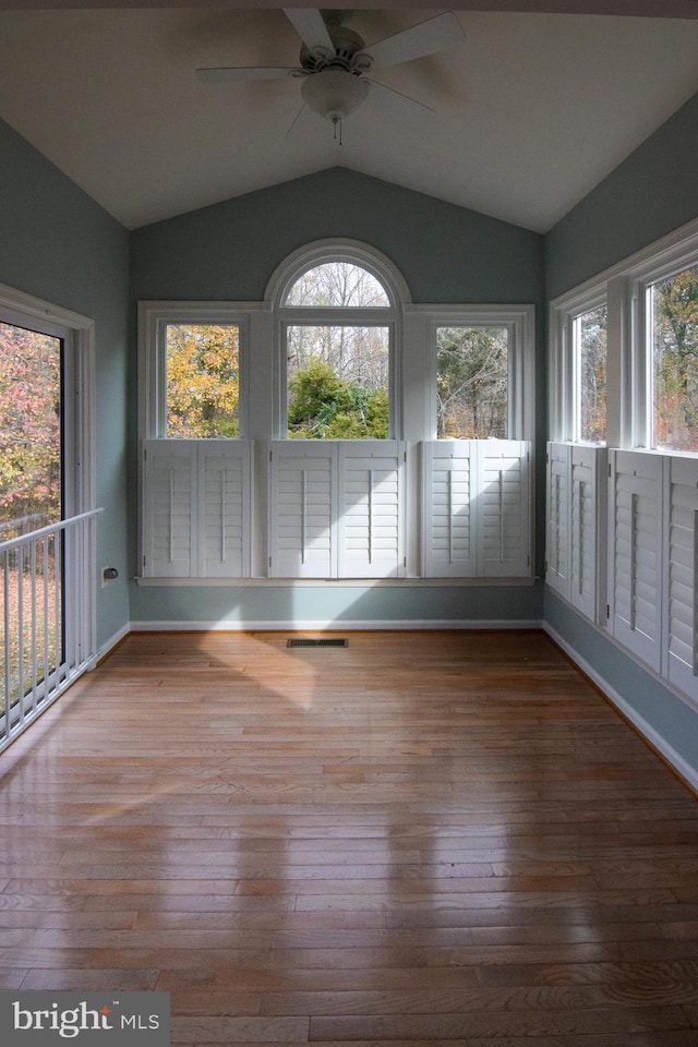 unfurnished sunroom with vaulted ceiling, ceiling fan, and a healthy amount of sunlight