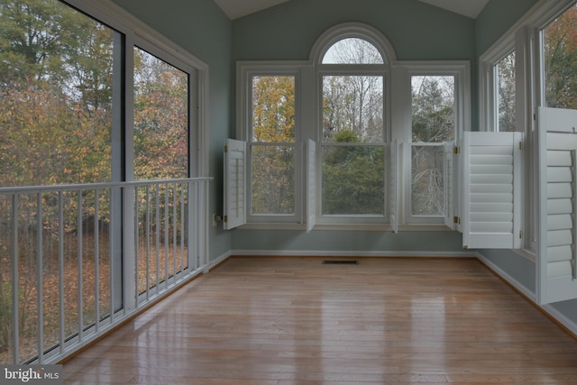 unfurnished sunroom with plenty of natural light and vaulted ceiling