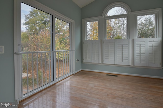 unfurnished sunroom with lofted ceiling and a wealth of natural light