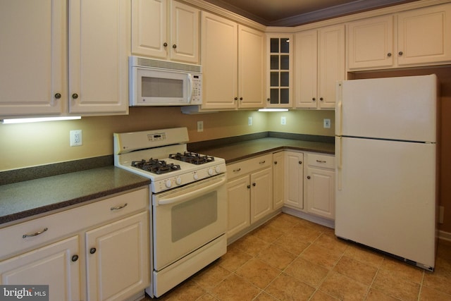 kitchen featuring white cabinets and white appliances