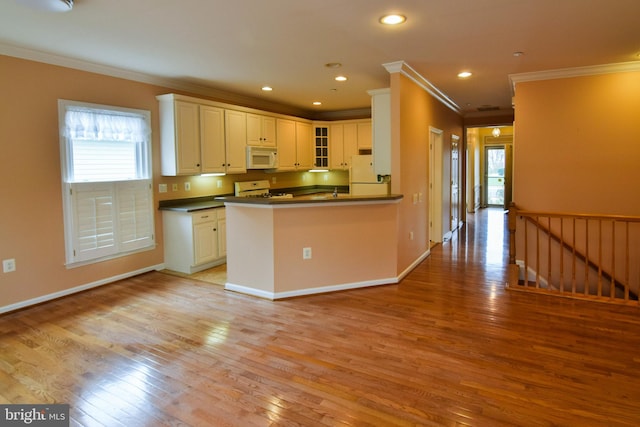 kitchen featuring white cabinetry, kitchen peninsula, light hardwood / wood-style floors, white appliances, and ornamental molding