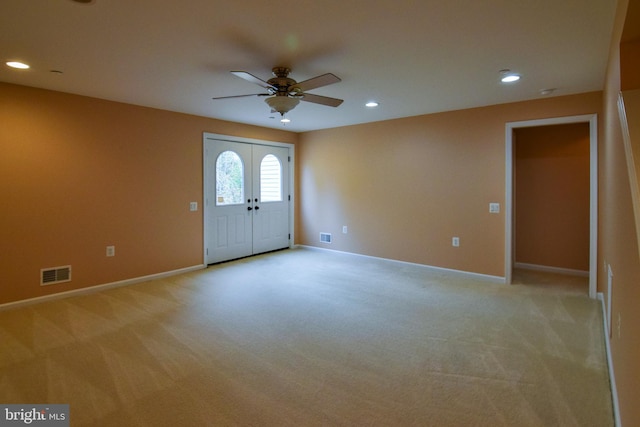 carpeted foyer featuring french doors and ceiling fan