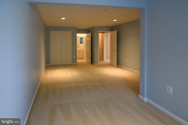 hall with light colored carpet