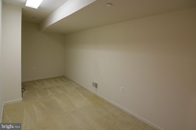 spare room featuring light colored carpet