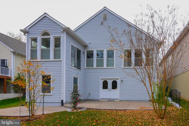 back of property with a patio