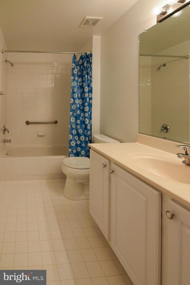 full bathroom with tile patterned floors, vanity, shower / tub combo, and toilet