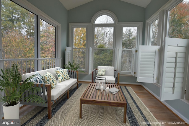 sunroom featuring a healthy amount of sunlight and vaulted ceiling