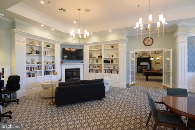 carpeted living room with built in features, crown molding, and an inviting chandelier