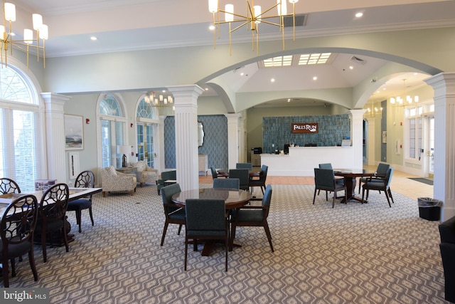 dining space featuring french doors, carpet, a chandelier, and ornamental molding