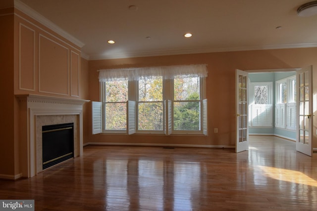 unfurnished living room with crown molding and light hardwood / wood-style flooring