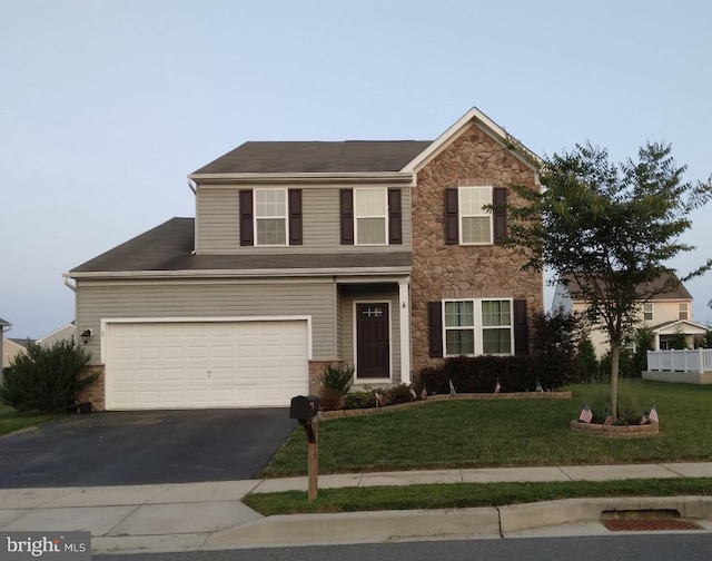 traditional home with driveway, stone siding, a garage, and a front yard