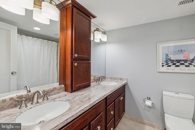 bathroom with vanity, toilet, and tile patterned flooring