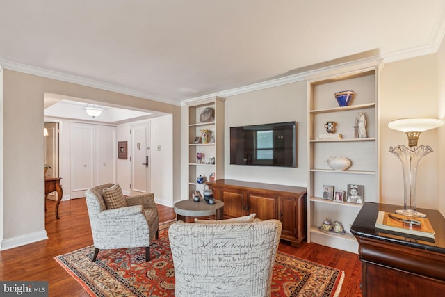 living room with ornamental molding, built in features, and wood-type flooring