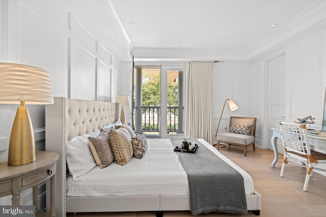 bedroom with light wood-type flooring, crown molding, and access to outside