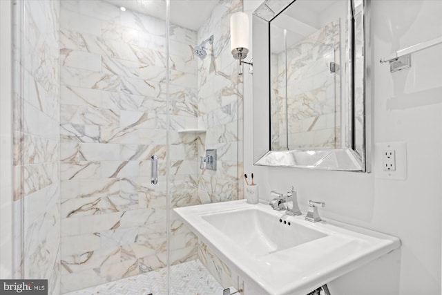 bathroom with sink and an enclosed shower