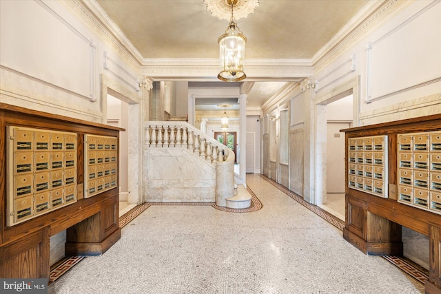 foyer entrance featuring ornamental molding and a mail area