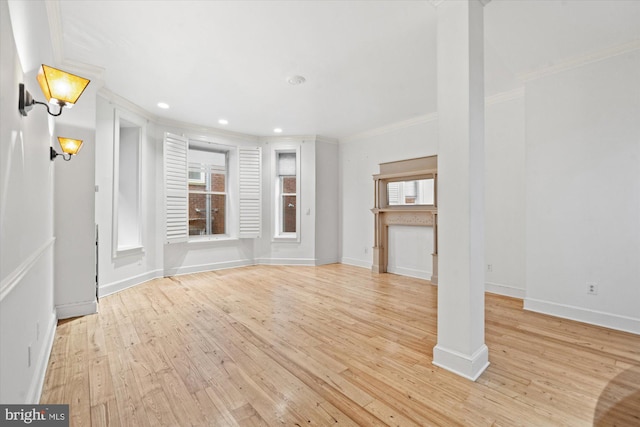 unfurnished living room with crown molding and light hardwood / wood-style floors