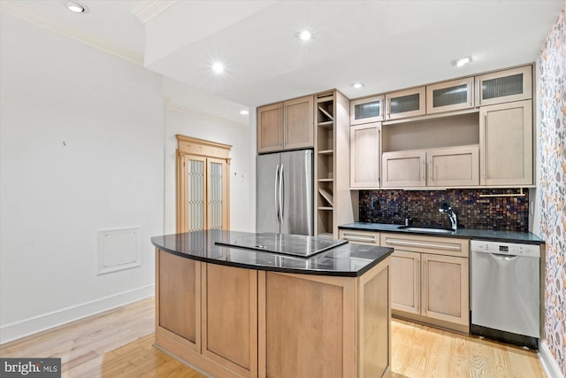 kitchen with light wood-type flooring, a center island, stainless steel appliances, light brown cabinets, and crown molding