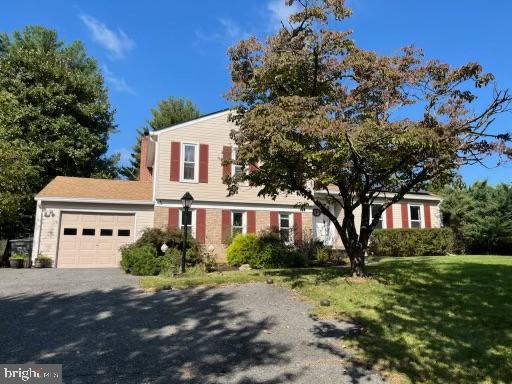 view of front facade with a front yard and a garage