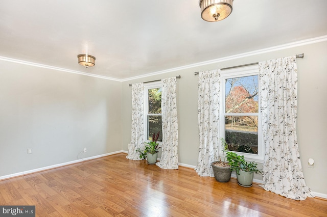 unfurnished room with ornamental molding and hardwood / wood-style flooring