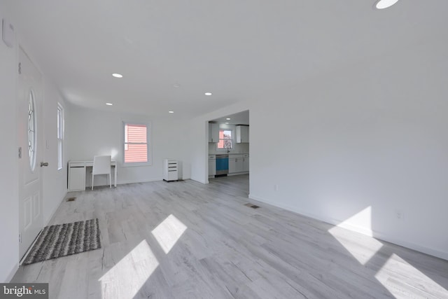 unfurnished living room featuring light hardwood / wood-style flooring