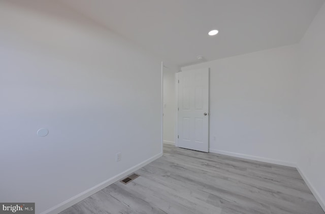 spare room with light hardwood / wood-style flooring