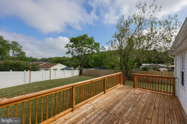 wooden deck with a lawn