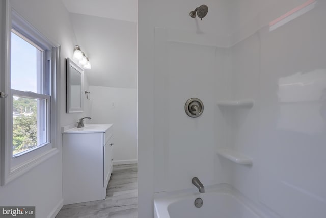 bathroom featuring tub / shower combination, vanity, and hardwood / wood-style flooring