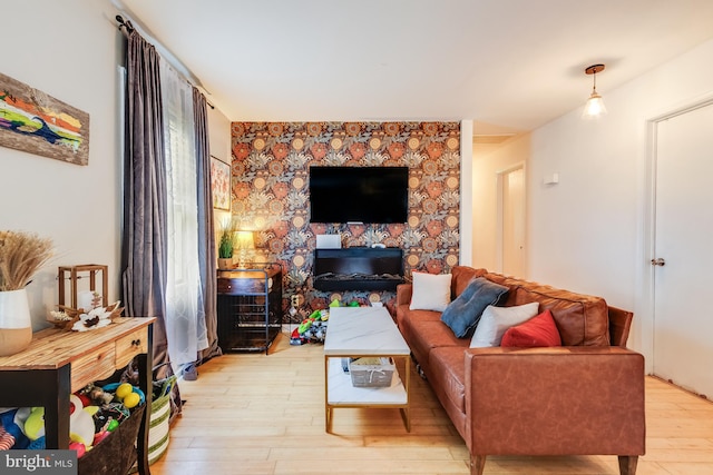 living room featuring light hardwood / wood-style flooring and a fireplace