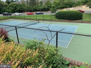 view of tennis court featuring fence