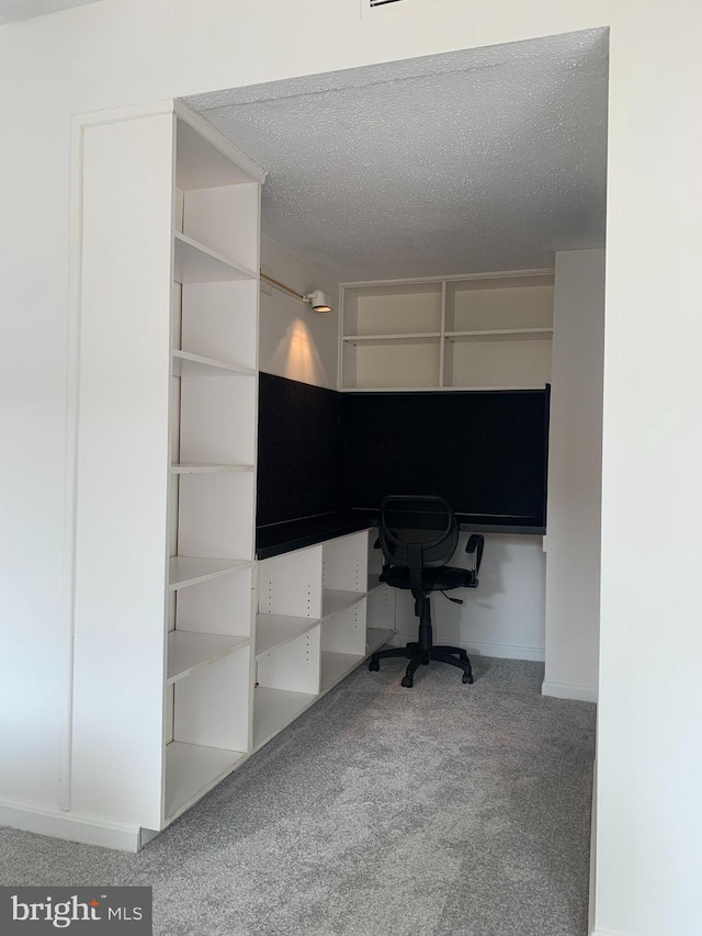 unfurnished office with a textured ceiling and carpet