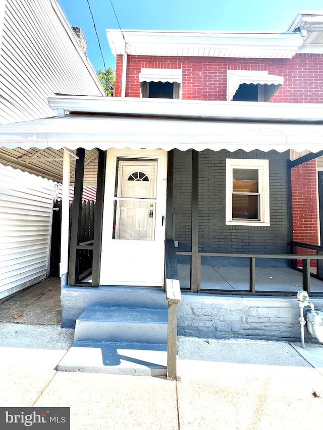 view of exterior entry featuring a carport