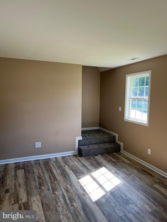 spare room with wood-type flooring