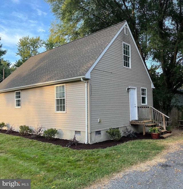 view of side of home with a yard