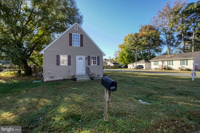 view of front of property with a front lawn and central AC unit