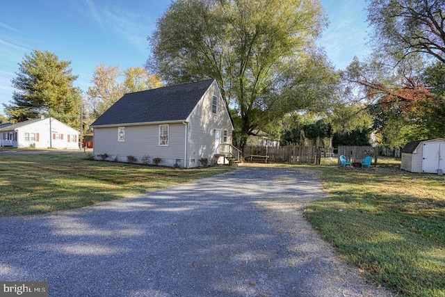 view of property exterior with a yard and a shed