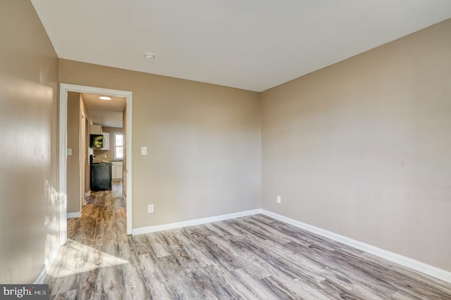 empty room with light hardwood / wood-style flooring