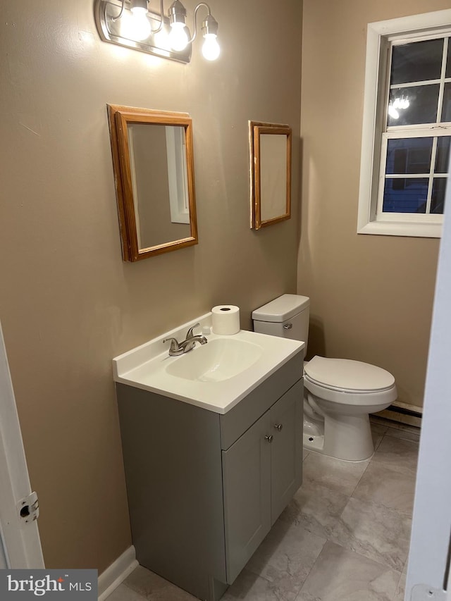 bathroom featuring vanity and toilet