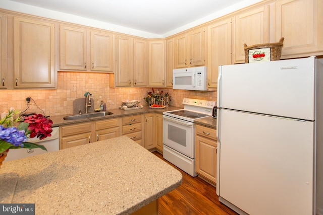 kitchen with sink, white appliances, backsplash, light brown cabinetry, and dark hardwood / wood-style flooring