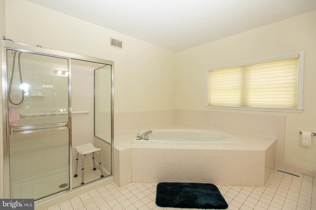 bathroom featuring tile patterned flooring and separate shower and tub