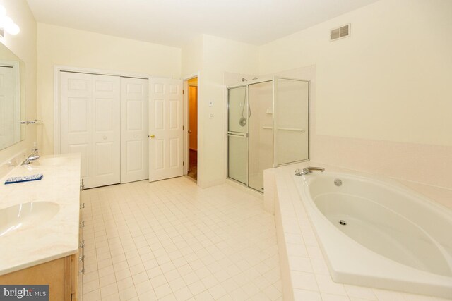 full bathroom with vanity, tile patterned floors, toilet, and separate shower and tub