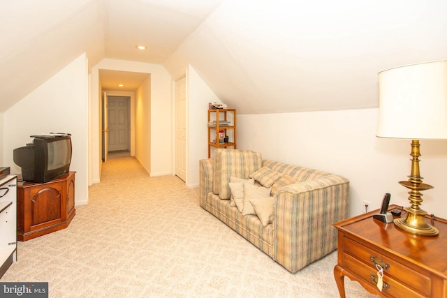 living area with vaulted ceiling and light carpet