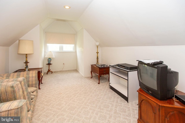 interior space featuring light carpet and vaulted ceiling