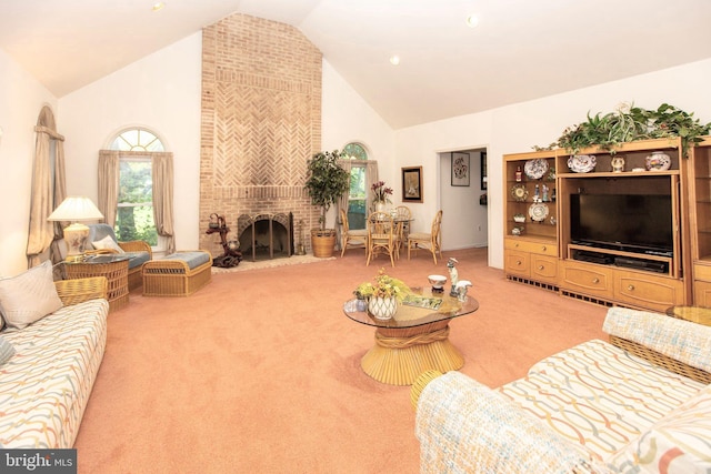 carpeted living room with a fireplace and high vaulted ceiling