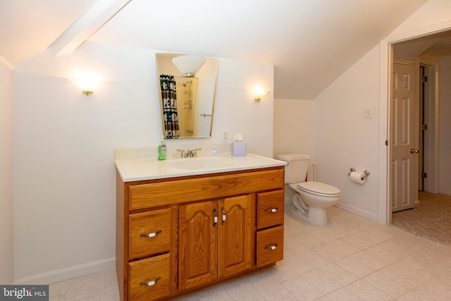 bathroom with vaulted ceiling, vanity, tile patterned flooring, and toilet