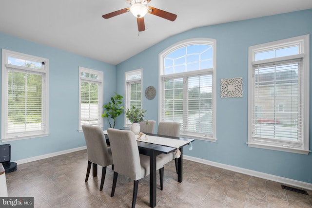 tiled dining area with lofted ceiling and ceiling fan