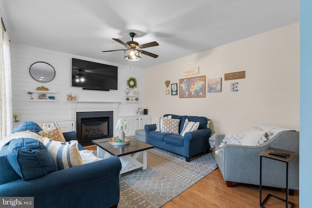 living room with ceiling fan and wood-type flooring