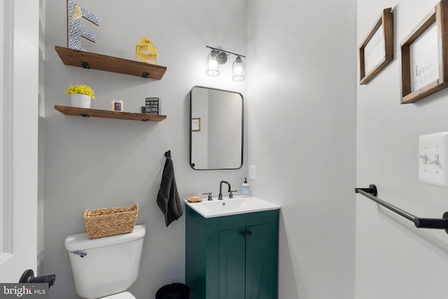 bathroom featuring toilet and vanity