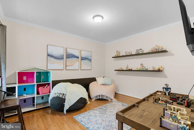 bedroom featuring crown molding and hardwood / wood-style flooring